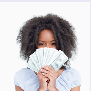 Young woman holding cash from early cashout of her lottery